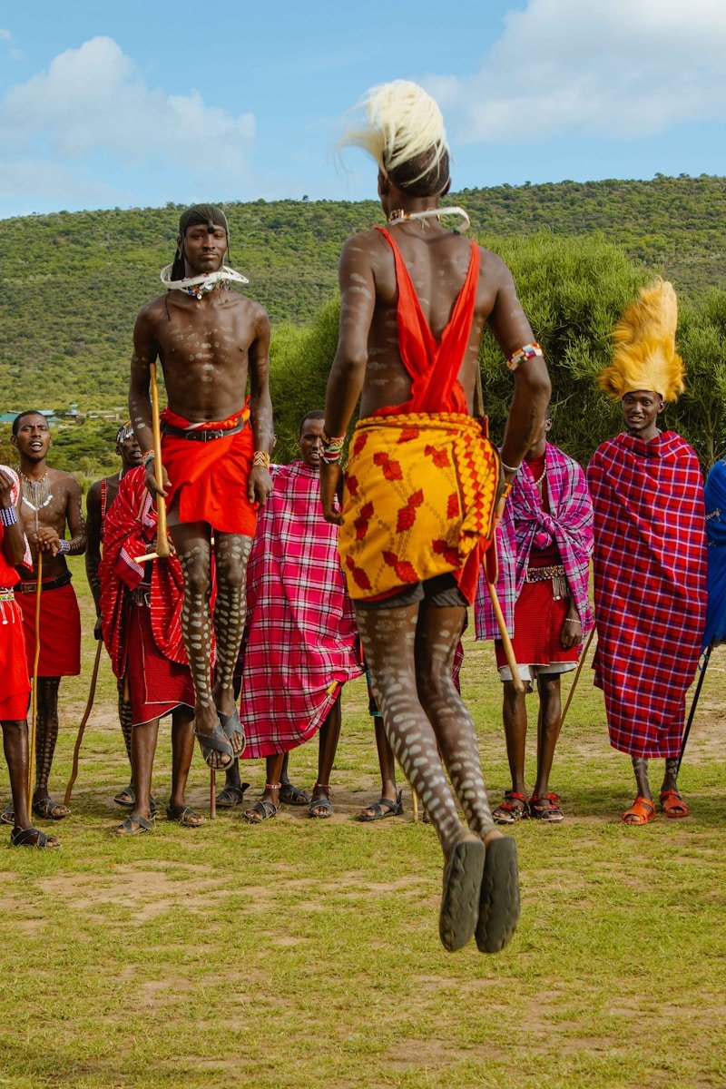 a group of people standing on top of a lush green field